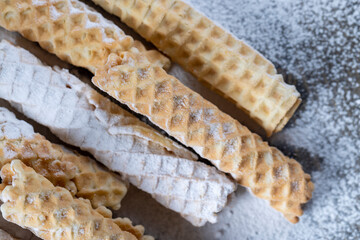 thin crispy waffles lie on a black table