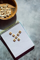 Slow down mantra on notebook in wooden letters