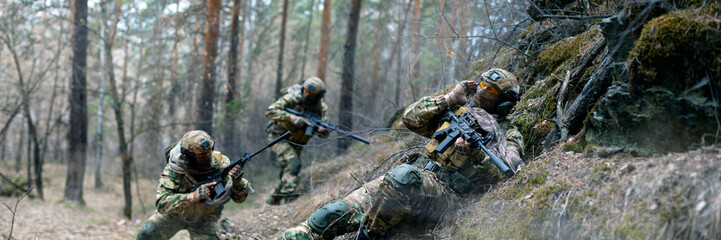 Three mercenaries during a clash in enemy territory. Special operation in the forest. The soldiers were ambushed. Collage - one model in 3 poses. - obrazy, fototapety, plakaty