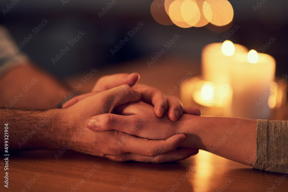 Poster itll be okay. closeup of two unrecognizable people holding hands over a dinner table with candle lig