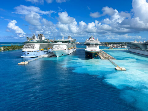 An aerial view of the cruise ship harbor in Nassau, Bahamas from a cruise ship that is sailing away.
