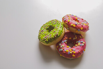 Fototapeta na wymiar Pink and green donuts with powder. Delicacy.