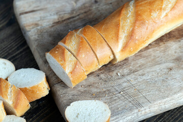 wheat baguette cut into pieces on a cutting board