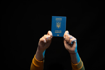 Ukraine national state biometric passport in hands. Symbol of Ukrainian statehood. Copy space