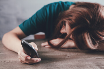 a woman dials a number on a home wired phone