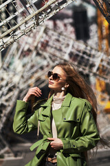 Obraz premium fashion model with long hair wearing sunglasses posing outdoor.
