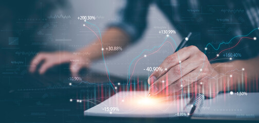 Man using pen write project of Stock market or forex trading graph and candlestick chart suitable for financial investment, Economy trends background for business idea, Corporate business technology,