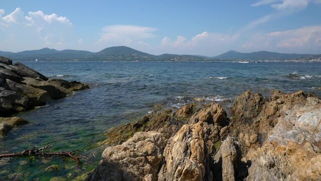 Beautiful view of the azure coast - French Riviera. Azure waves touch the sharp and beautiful French rocks.