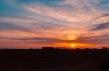 Beautiful sunset with dramatic clouds near Tabertshausen, Bavaria, Germany