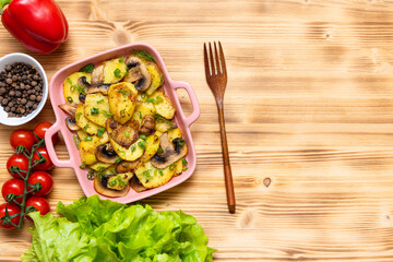 Fragrant tartiflet with bacon, herbs and vegetables at home on a wooden background. View from above.