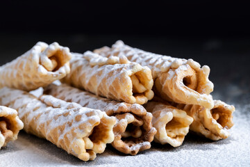 thin crispy waffles lie on a black table