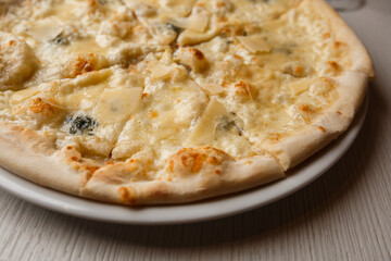 Four cheese pizza quattro formaggi close up photo.
