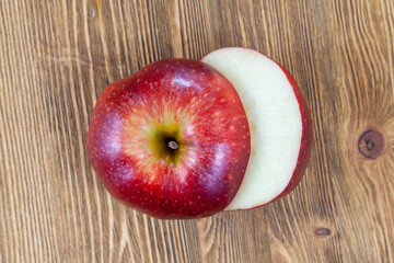 a red ripe apple cut into pieces on the table