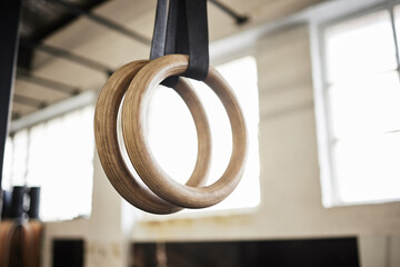 Lets build some muscle. Still life shot of gymnastic rings in a gym.