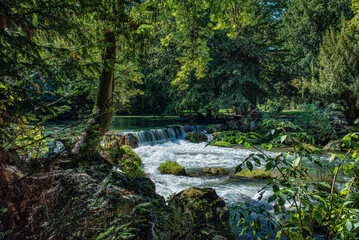 Fototapeta premium A waterfall on a river in English Park in Munich.