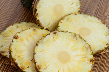 cut into pieces ripe yellow pineapple on the table