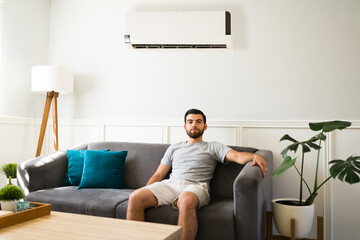 Man enjoying air conditioning at home