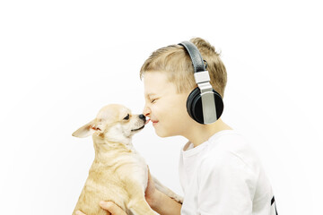Portrait of a boy in headphones and his pet on a white background