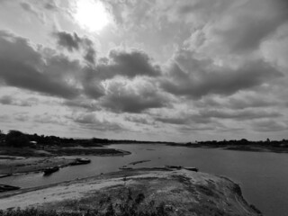 Black and white photo of clouds over the river