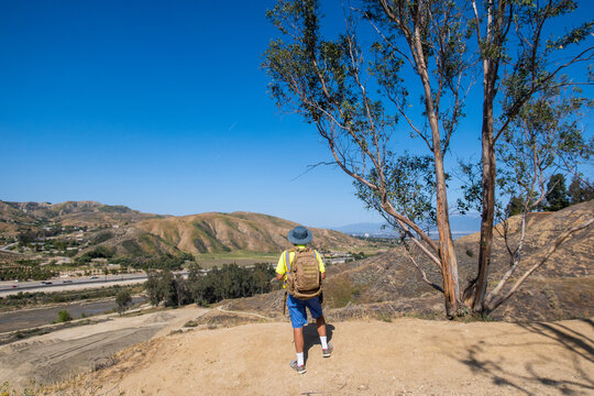 A Hiker Standing On A Hill Overlooking San Timoteo Canyon