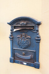 old metal mailbox on a smooth wall. copy of the space. mailbox for paper correspondence