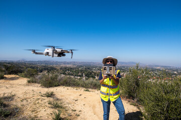 A Woman Certified Part 107 FAA Drone Pilot Conducting an Aerial UAV Survey of a Housing Project