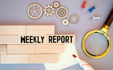 weekly report - text written in notebook on financial charts. - obrazy, fototapety, plakaty