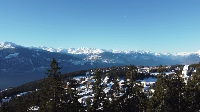 Crans Montana Ski resort, 4k drone video footage of crans montana ski resort flying through the valley of Crans Montana, Swiss Alps, Ski Resort in perfect light in the morning of fresh snow.