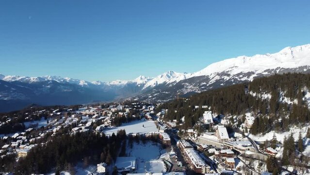Crans Montana Ski resort, 4k drone video footage of crans montana ski resort flying through the valley of Crans Montana, Swiss Alps, Ski Resort in perfect light in the morning of fresh snow.