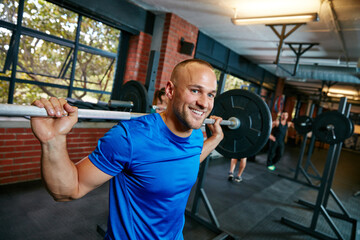 Keep calm and build muscles. Shot of a man doing weight training at the gym.