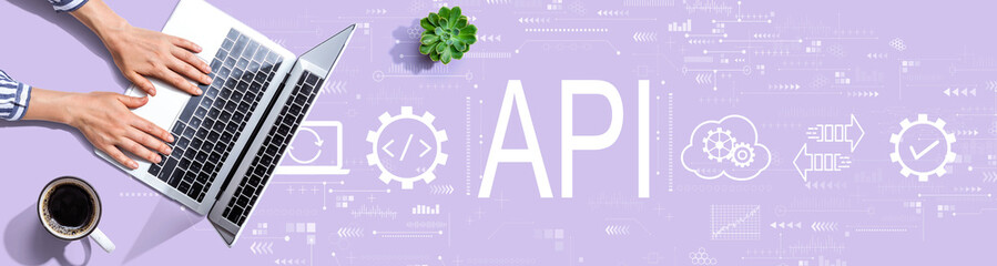 Obraz na płótnie Canvas API - application programming interface concept with person using a laptop computer