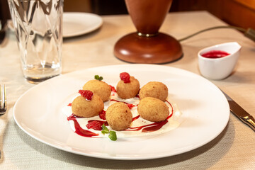 Deep fried balls of arborio rice stuffed with mozzarella cheese