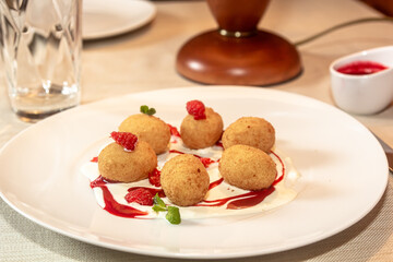 Deep fried balls of arborio rice stuffed with mozzarella cheese