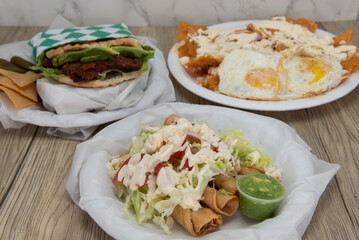Lantino cuisine choices served buffet style on the table with the flour tortilla flautas featured...