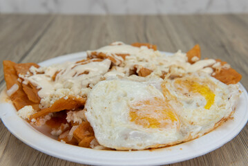 Deep fried eggs tops this delicious Latino flavored breakfast meal of Chilaquiles