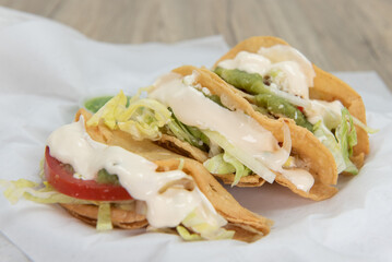 Three tacos de papas are loaded with meat and potatoes for a very hearty Mexican food meal
