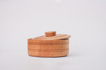 Brown wooden eco-friendly pot with cover for salt or pepper, spices isolated on white background. Natural materials kitchenware