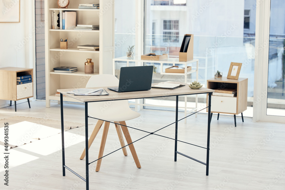 Poster your workspace is ready for you. shot of an empty office with a laptop on the table.