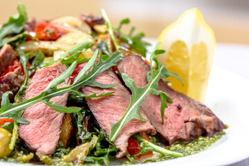Rare roast beef meal with organic root vegetables