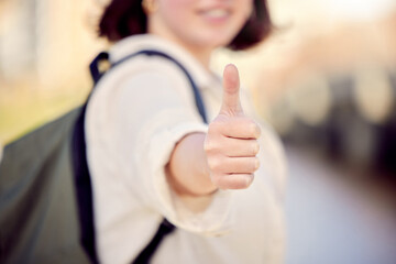 Do good and youll attract good. Cropped shot of a woman showing thumbs up while standing outside.