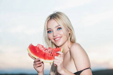 Summer portrait woman is holding a slice of watermelon.