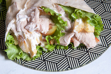 shawarma chicken with lettuce, french fries, onion and garlic