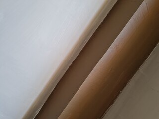Abstract background photo depicting a wall with white paint combined with brown paint
