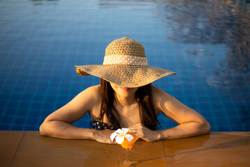 Women relaxing near luxury swimming pool
