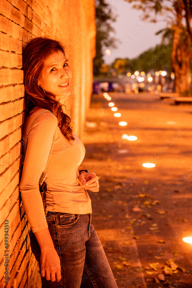 Canvas Prints Thai woman with old brick wall in the evening