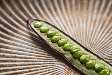 Open Guaje seed pod on a plate with edible seed in Oaxaca, Mexico.