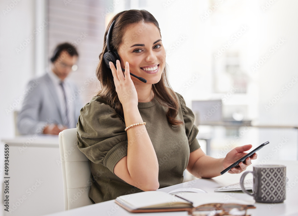 Poster Keeping the channels of communication open for her customers. Portrait of a young call centre agent using a cellphone while working in an office.