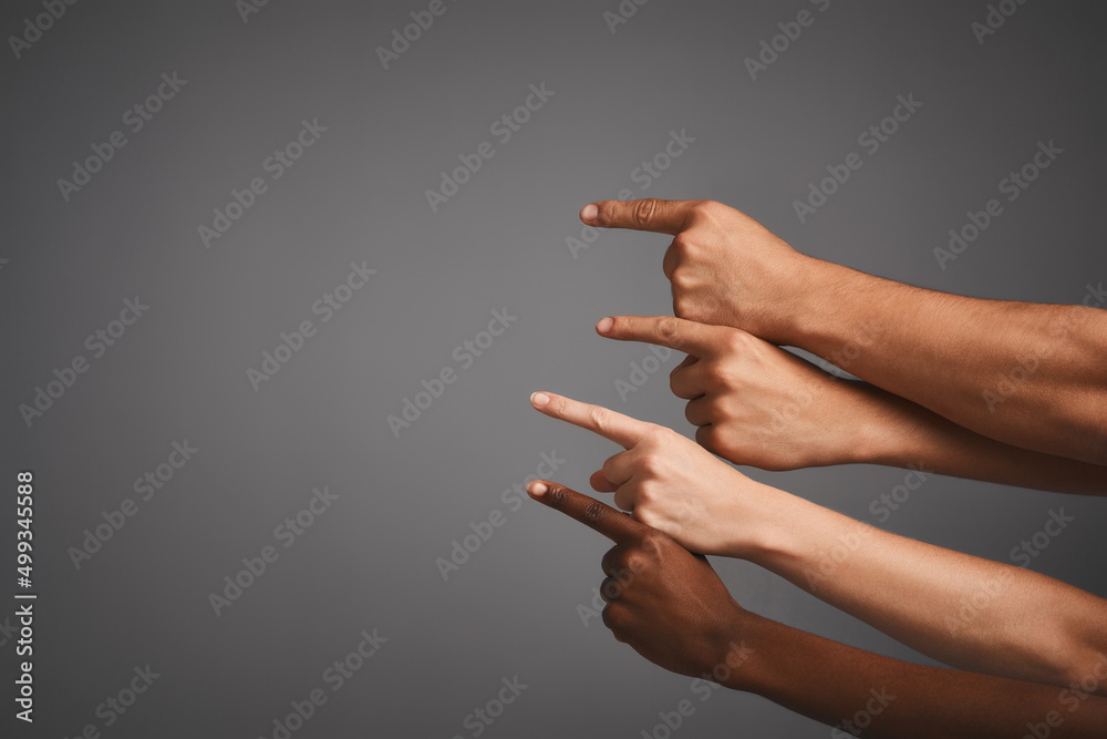 Poster Pointing out some prime copyspace. Studio shot of unidentifiable hands pointing upwards towards blank copyspace.