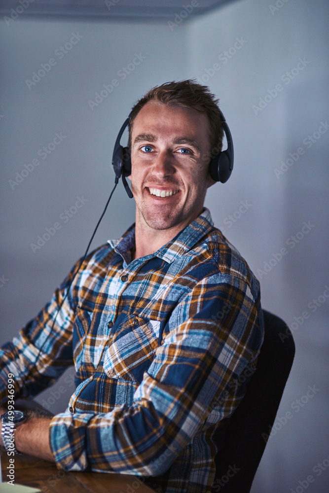 Poster hello, operator. portrait of a happy customer service agent wearing a headset while sitting in the o