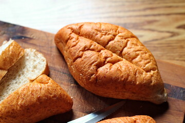 Baked bread placed on a wooden table. Flat-lat photo.